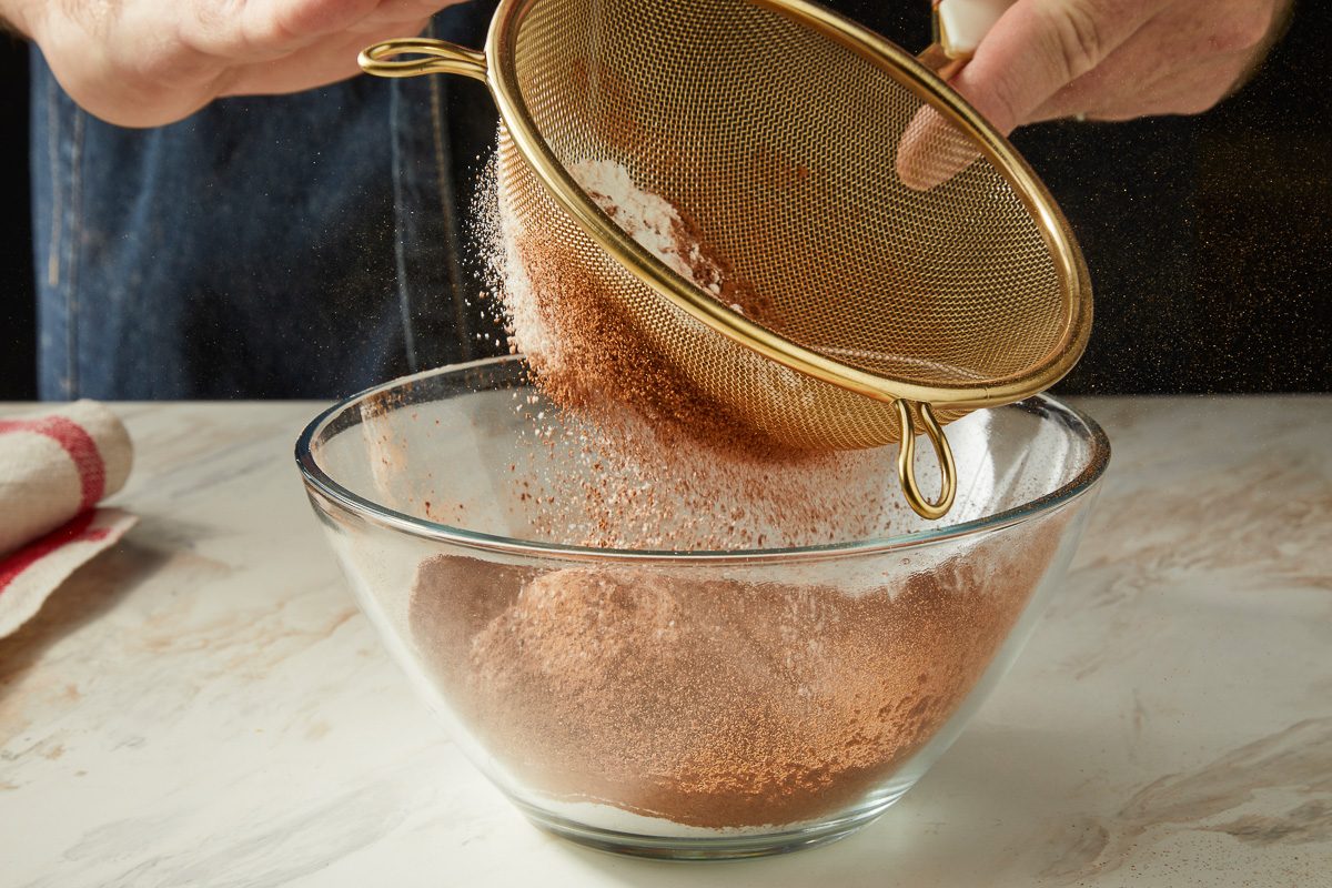 sifting the flour, cocoa, baking powder, baking soda and salt in a small bowl