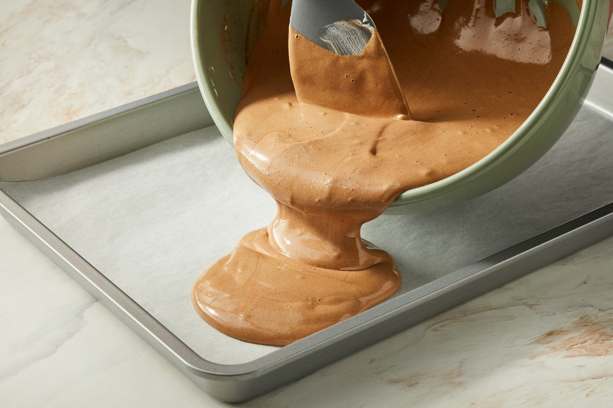 batter being transferred to a pan