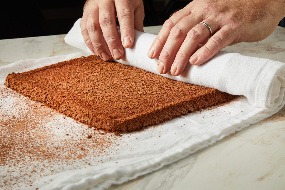rolling up cake in kitchen towel
